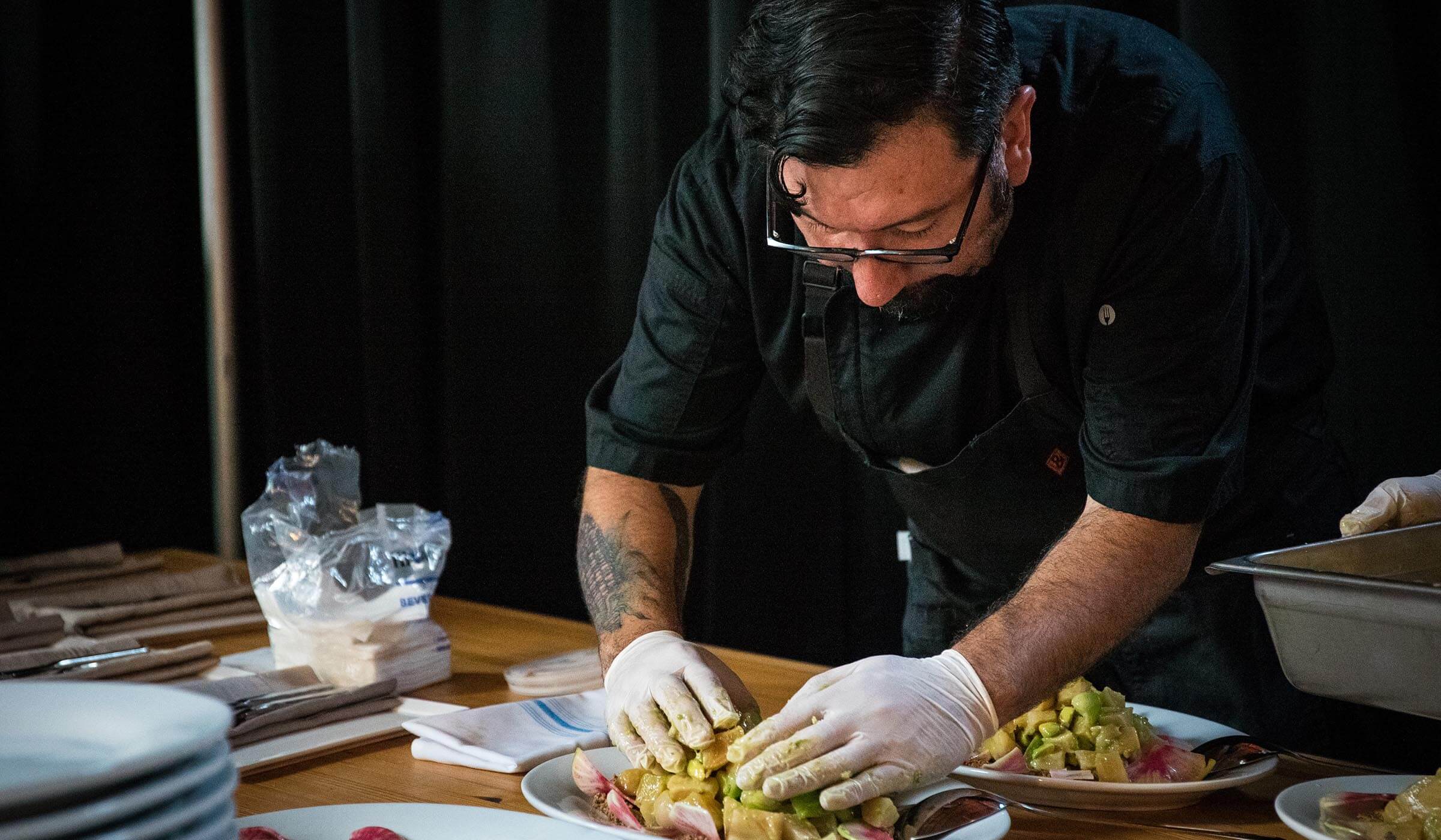 chef preparing food for a La Victoria 100 year anniversary event